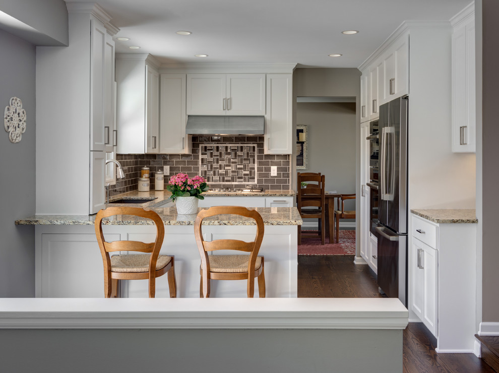 Mid-sized transitional u-shaped dark wood floor eat-in kitchen photo in Minneapolis with a single-bowl sink, shaker cabinets, white cabinets, granite countertops, gray backsplash, subway tile backsplash, paneled appliances and a peninsula
