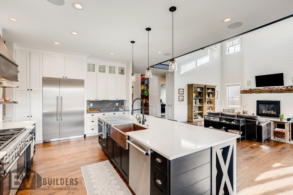 Kitchen - mid-sized farmhouse medium tone wood floor and brown floor kitchen idea in Denver with a farmhouse sink, shaker cabinets, black cabinets, quartz countertops, white backsplash, shiplap backsplash, stainless steel appliances, an island and white countertops