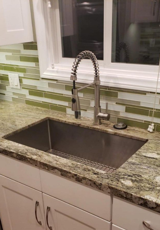 This is an example of a medium sized contemporary kitchen in Los Angeles with a single-bowl sink, white cabinets, granite worktops, green splashback and green worktops.