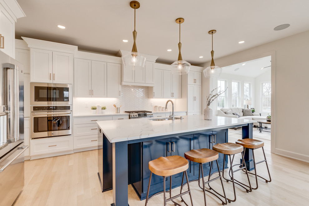 Eat-in kitchen - transitional l-shaped cork floor and beige floor eat-in kitchen idea in Minneapolis with white backsplash, an island, white countertops, shaker cabinets, white cabinets and stainless steel appliances