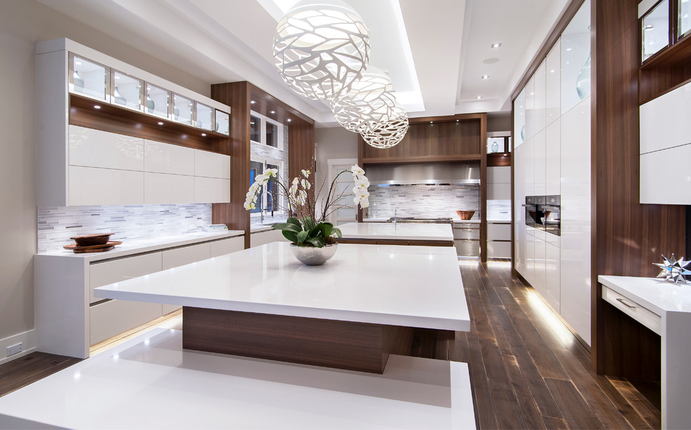 Design ideas for a large contemporary l-shaped kitchen/diner in Calgary with a triple-bowl sink, flat-panel cabinets, white cabinets, quartz worktops, multi-coloured splashback, matchstick tiled splashback, stainless steel appliances, dark hardwood flooring and an island.