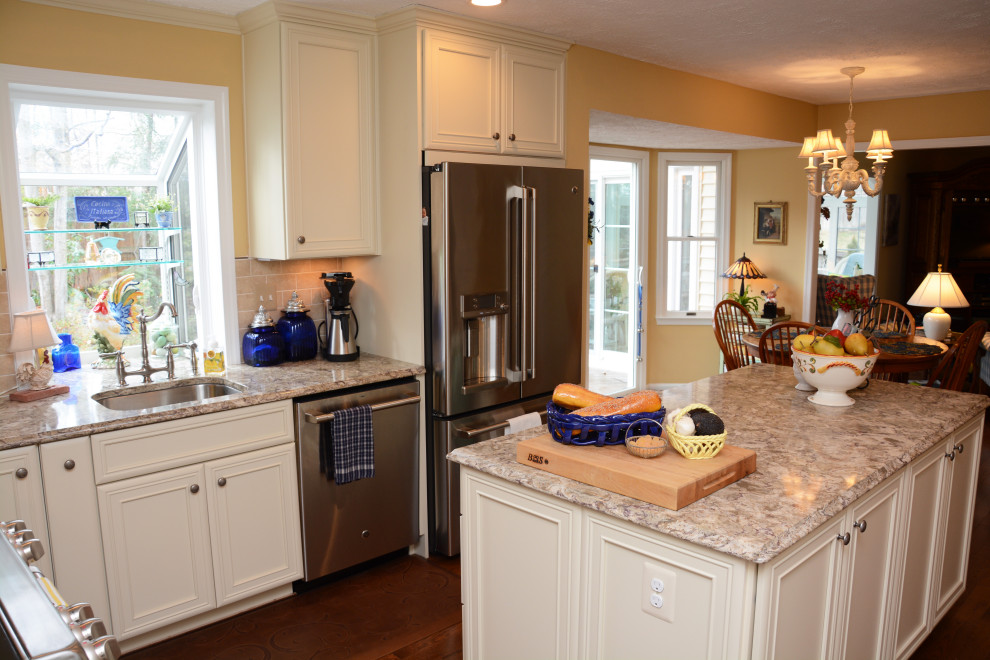 Large french country u-shaped dark wood floor and brown floor eat-in kitchen photo in DC Metro with an undermount sink, recessed-panel cabinets, beige cabinets, quartz countertops, beige backsplash, stainless steel appliances, an island and beige countertops