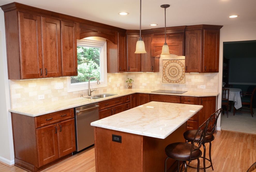 Inspiration for a mid-sized timeless l-shaped light wood floor and brown floor eat-in kitchen remodel in DC Metro with a double-bowl sink, recessed-panel cabinets, medium tone wood cabinets, beige backsplash, stainless steel appliances, an island and beige countertops
