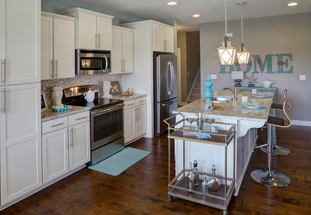 Mid-sized transitional galley open concept kitchen photo in Other with an undermount sink, shaker cabinets, white cabinets, granite countertops, blue backsplash, stainless steel appliances and an island