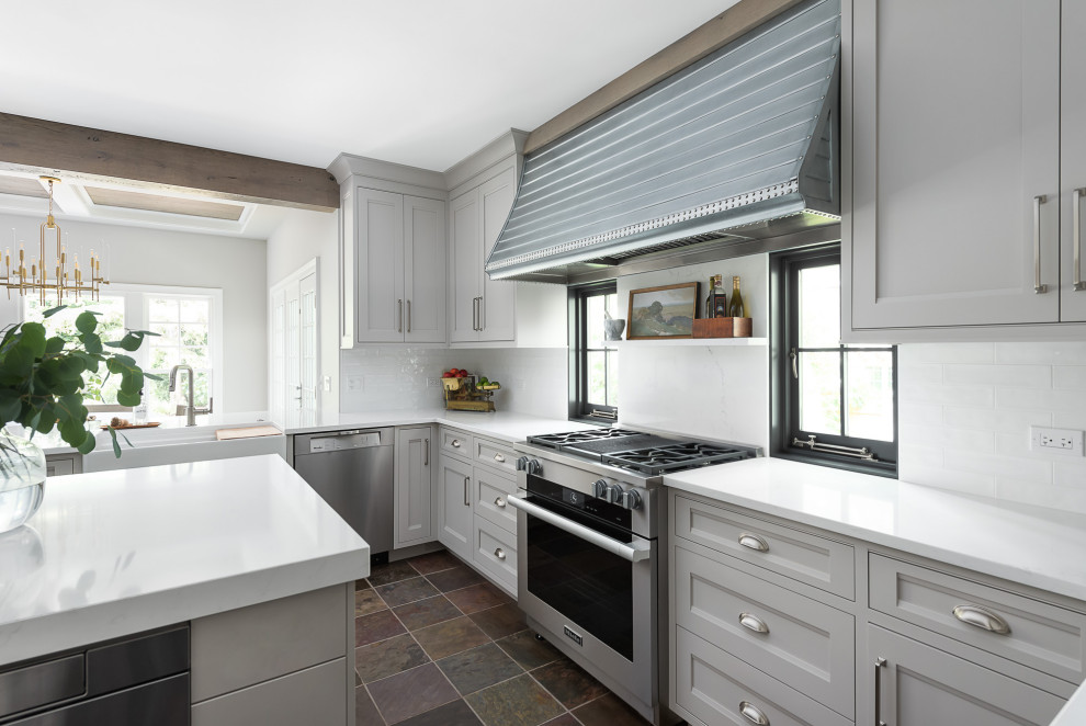 Eat-in kitchen - mid-sized cottage u-shaped slate floor eat-in kitchen idea in Chicago with a farmhouse sink, flat-panel cabinets, gray cabinets, quartz countertops, white backsplash, subway tile backsplash, paneled appliances, an island and white countertops