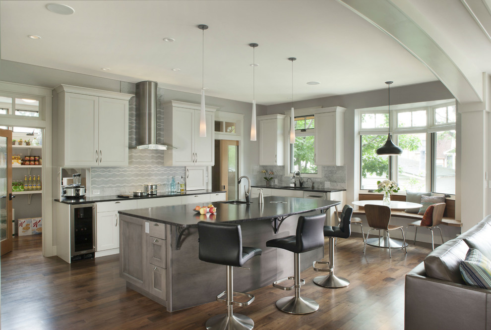 Example of a transitional dark wood floor open concept kitchen design in Denver with an undermount sink, shaker cabinets, white cabinets, multicolored backsplash and an island