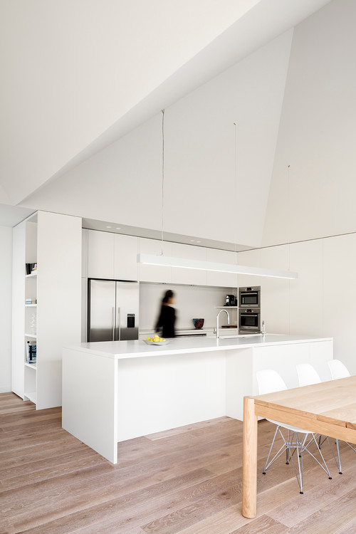 Experience Timeless Beauty with Minimalist Kitchen Ideas: All White Kitchen Design and a Vaulted Ceiling