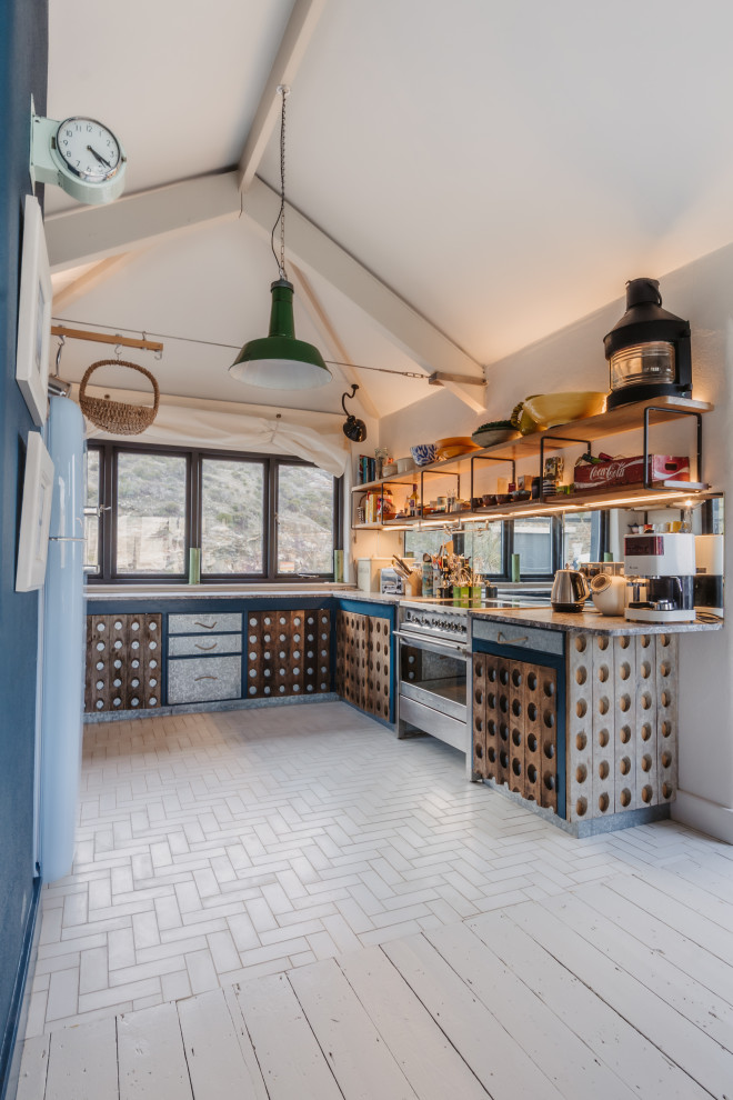 Medium sized coastal u-shaped kitchen in Cornwall with marble worktops, cement flooring, no island, white floors, black worktops, medium wood cabinets and a vaulted ceiling.