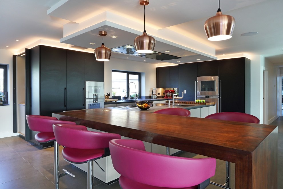 Medium sized contemporary l-shaped kitchen in London with flat-panel cabinets and an island.
