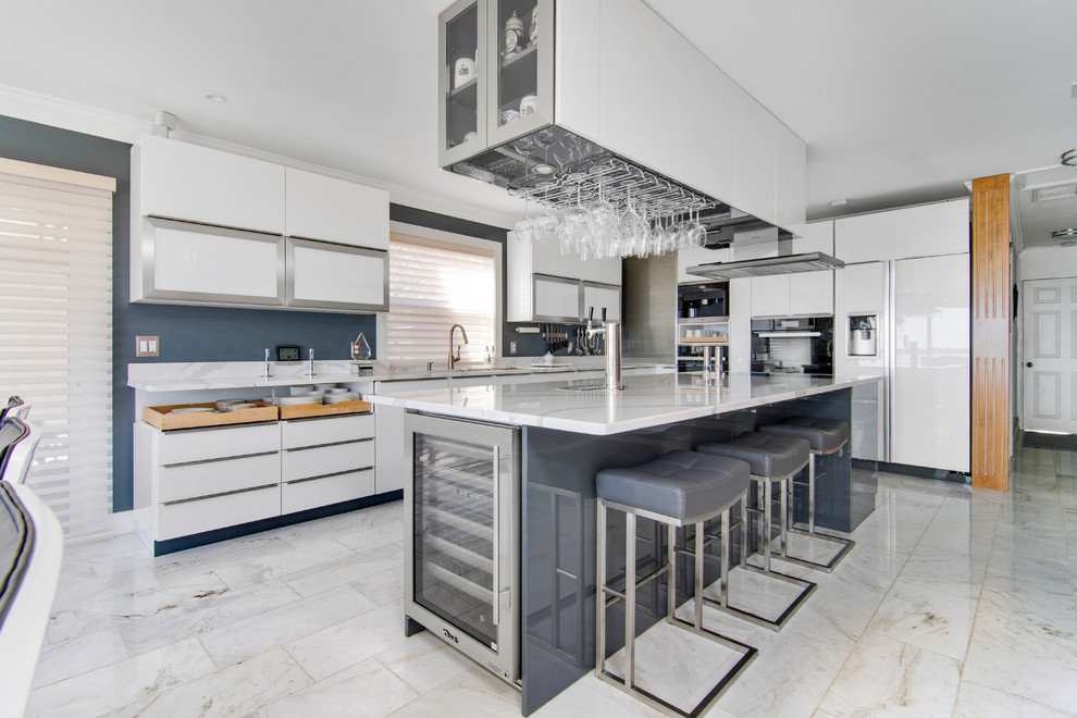 Inspiration for a large contemporary l-shaped marble floor and white floor eat-in kitchen remodel in Jacksonville with an undermount sink, flat-panel cabinets, white cabinets, marble countertops, paneled appliances and an island
