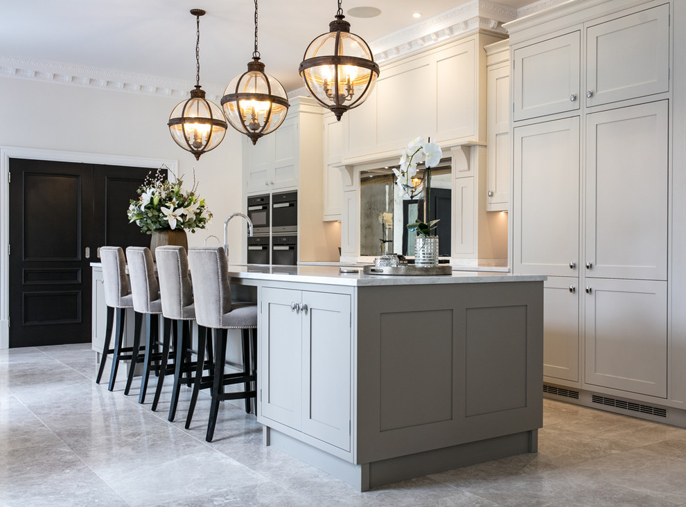 Eat-in kitchen - large traditional single-wall marble floor and gray floor eat-in kitchen idea in Surrey with a drop-in sink, shaker cabinets, gray cabinets, solid surface countertops, metallic backsplash, glass sheet backsplash, stainless steel appliances, an island and white countertops