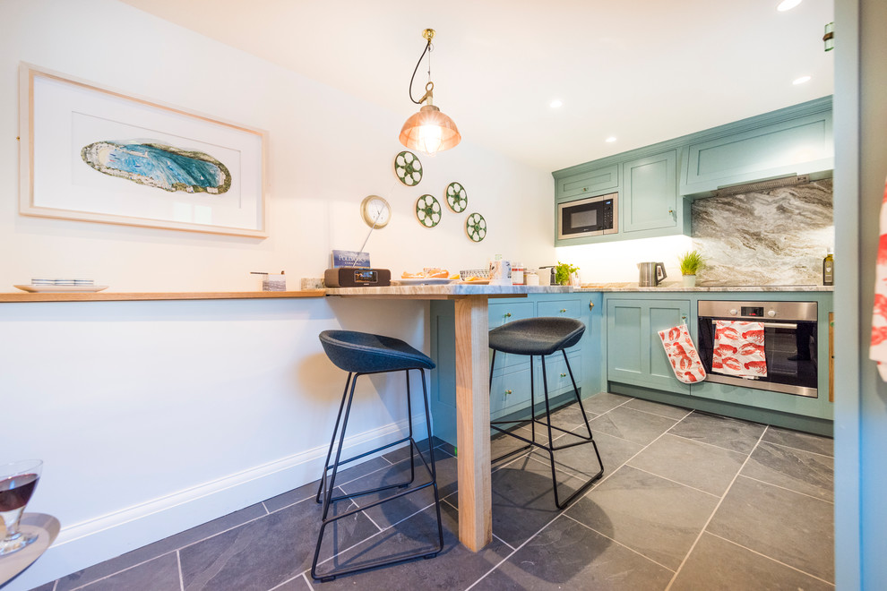 Nautical kitchen in Cornwall with granite worktops, stainless steel appliances and grey floors.