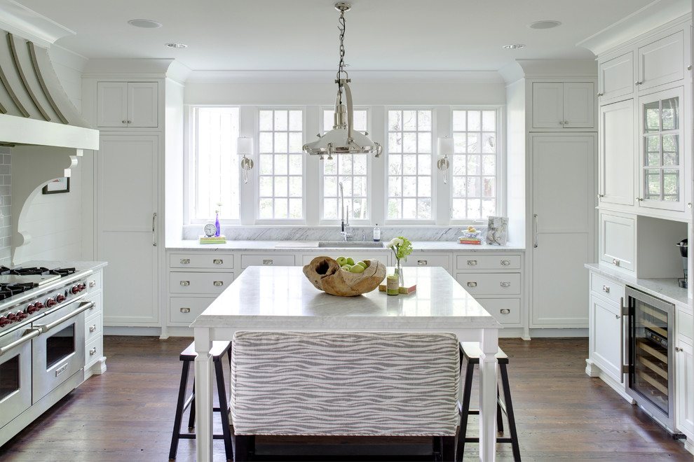 Transitional u-shaped dark wood floor kitchen photo in Raleigh with an undermount sink, shaker cabinets, white cabinets, gray backsplash, subway tile backsplash, stainless steel appliances and an island