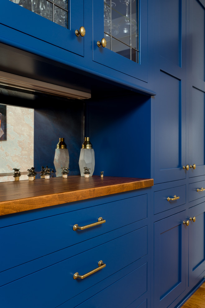 Inspiration for a small traditional l-shaped kitchen/diner in Louisville with shaker cabinets, blue cabinets, wood worktops, metallic splashback, mirror splashback, light hardwood flooring, multiple islands, brown floors and brown worktops.