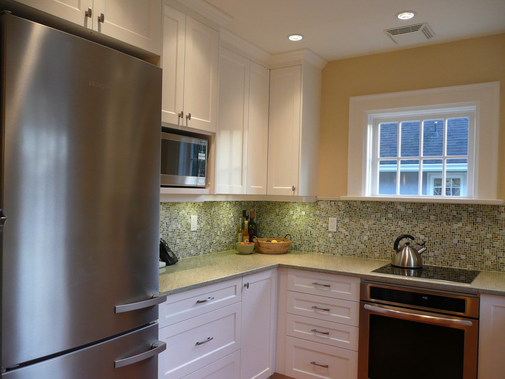 Example of a classic u-shaped eat-in kitchen design in Vancouver with an undermount sink, shaker cabinets, white cabinets, quartz countertops, green backsplash, mosaic tile backsplash and stainless steel appliances