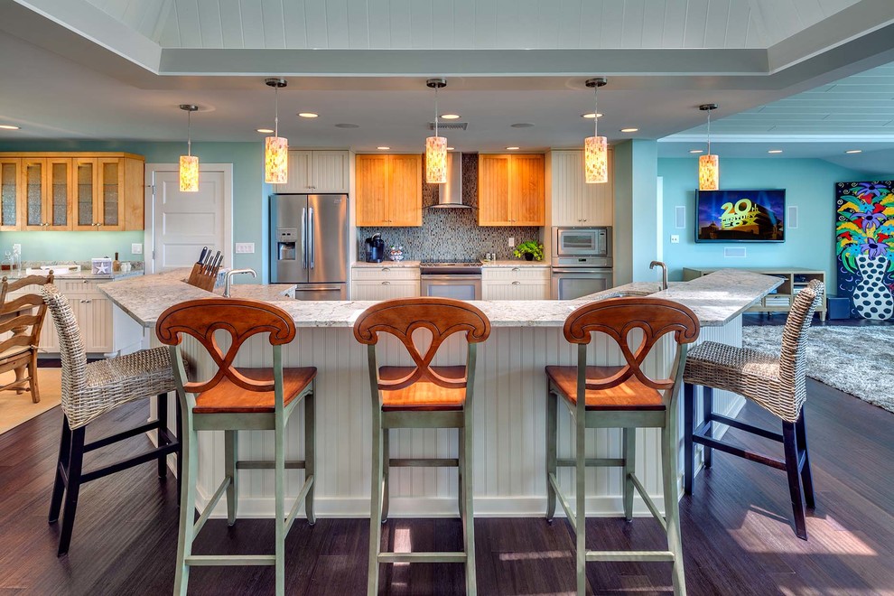 This is an example of a medium sized world-inspired u-shaped open plan kitchen in Tampa with a double-bowl sink, louvered cabinets, white cabinets, engineered stone countertops, multi-coloured splashback, mosaic tiled splashback, stainless steel appliances, dark hardwood flooring, a breakfast bar and brown floors.