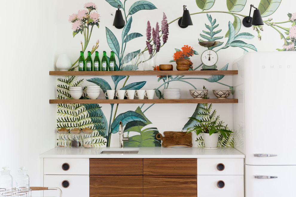 Inspiration for a small eclectic single-wall kitchen remodel in New York with an undermount sink, flat-panel cabinets, medium tone wood cabinets, quartz countertops, multicolored backsplash and white countertops