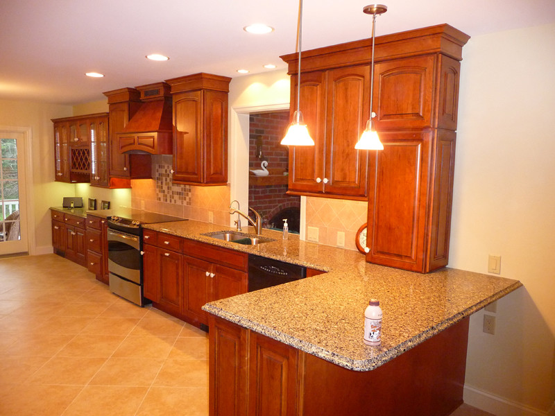 Example of a classic l-shaped porcelain tile eat-in kitchen design in Philadelphia with an undermount sink, raised-panel cabinets, red cabinets, quartz countertops, ceramic backsplash and stainless steel appliances