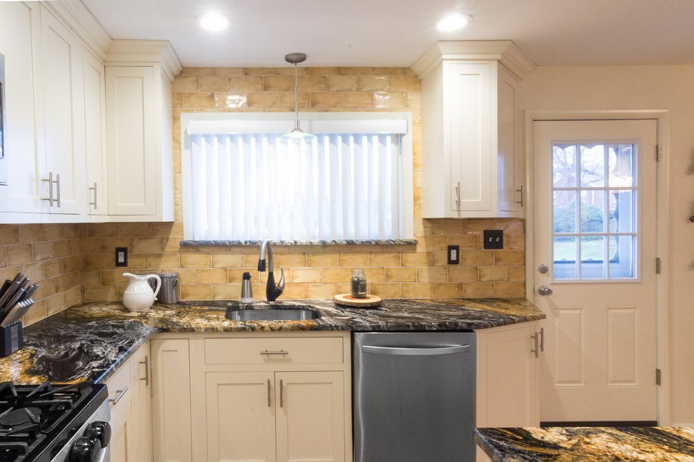 Mid-sized tuscan l-shaped eat-in kitchen photo in Philadelphia with an undermount sink, shaker cabinets, white cabinets, granite countertops, beige backsplash, ceramic backsplash, stainless steel appliances, an island and multicolored countertops