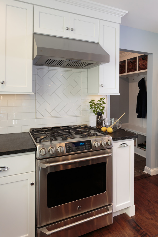 Stainless Steel Stove and Hood with Herringbone Backsplash