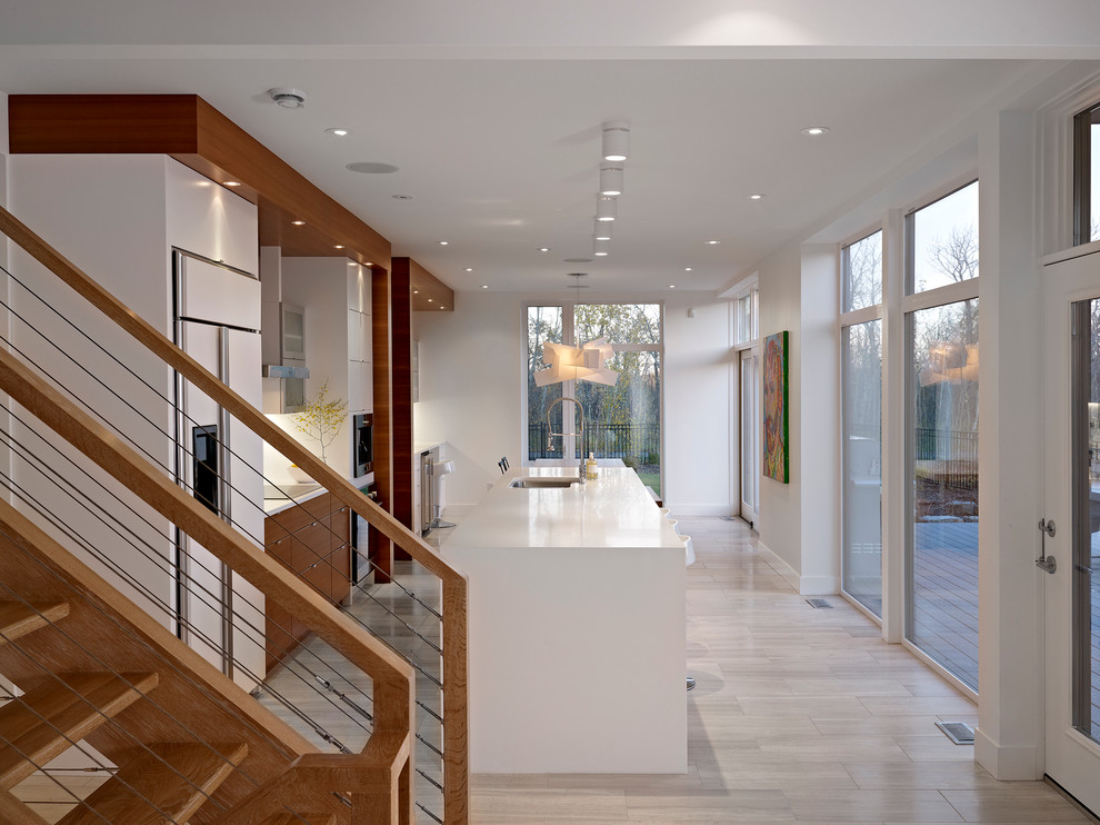 Eat-in kitchen - contemporary galley eat-in kitchen idea in Edmonton with white appliances, an undermount sink, flat-panel cabinets and white cabinets