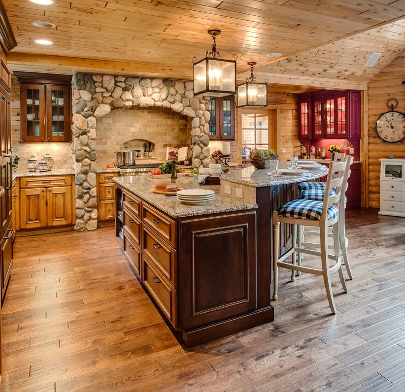 Inspiration for a mid-sized rustic l-shaped medium tone wood floor and brown floor open concept kitchen remodel in Miami with a farmhouse sink, raised-panel cabinets, dark wood cabinets, granite countertops, beige backsplash, stone tile backsplash, paneled appliances, an island and gray countertops