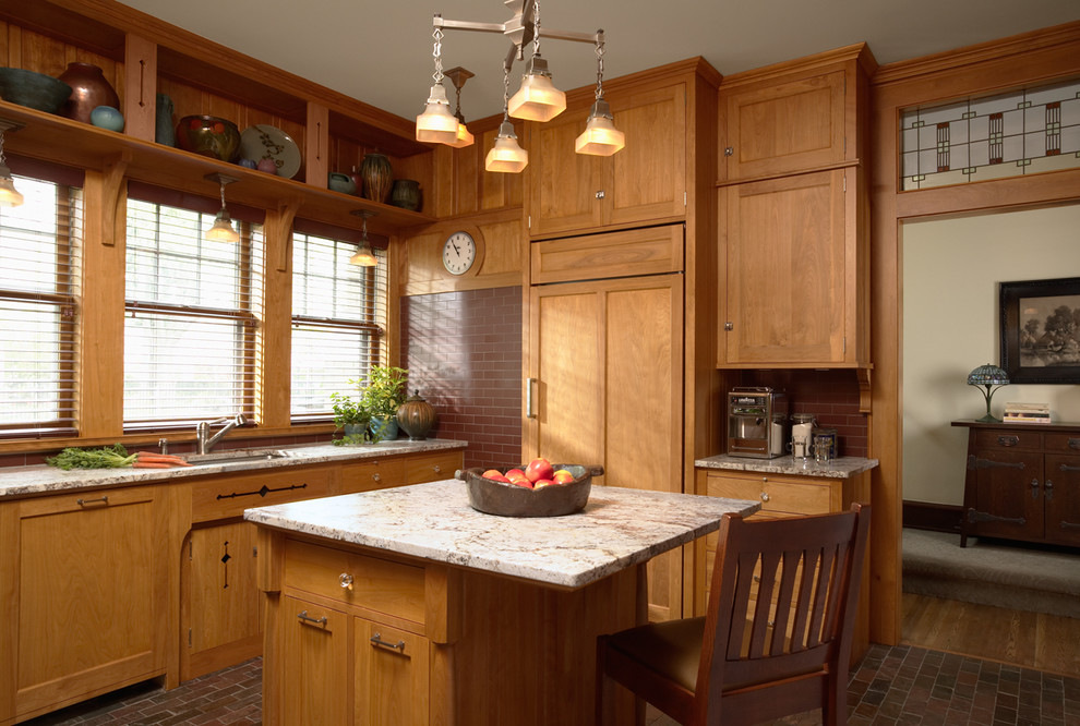 Foto på ett amerikanskt kök, med en undermonterad diskho, skåp i shakerstil, skåp i mellenmörkt trä, integrerade vitvaror, tegelgolv och en köksö