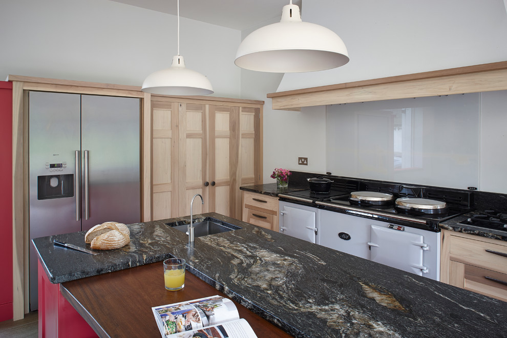 This is an example of a large country galley kitchen/diner in Surrey with a built-in sink, shaker cabinets, light wood cabinets, granite worktops, glass sheet splashback, stainless steel appliances, ceramic flooring and an island.