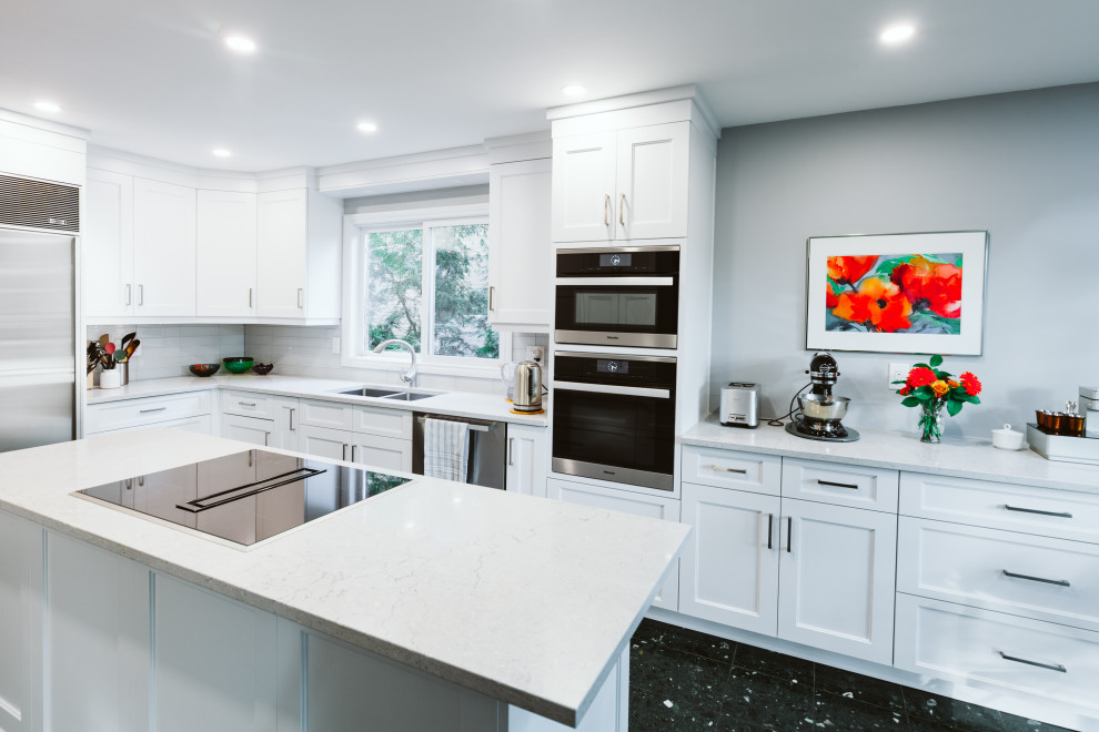 Enclosed kitchen - mid-sized transitional l-shaped ceramic tile and green floor enclosed kitchen idea in Toronto with an undermount sink, shaker cabinets, white cabinets, quartz countertops, blue backsplash, glass tile backsplash, stainless steel appliances, an island and gray countertops