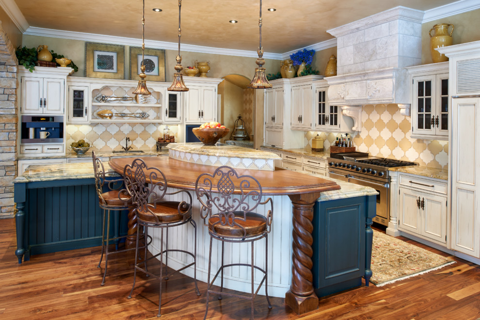 Example of a large tuscan l-shaped medium tone wood floor eat-in kitchen design in Denver with beaded inset cabinets, white cabinets, wood countertops, multicolored backsplash, an island, an undermount sink, terra-cotta backsplash and stainless steel appliances
