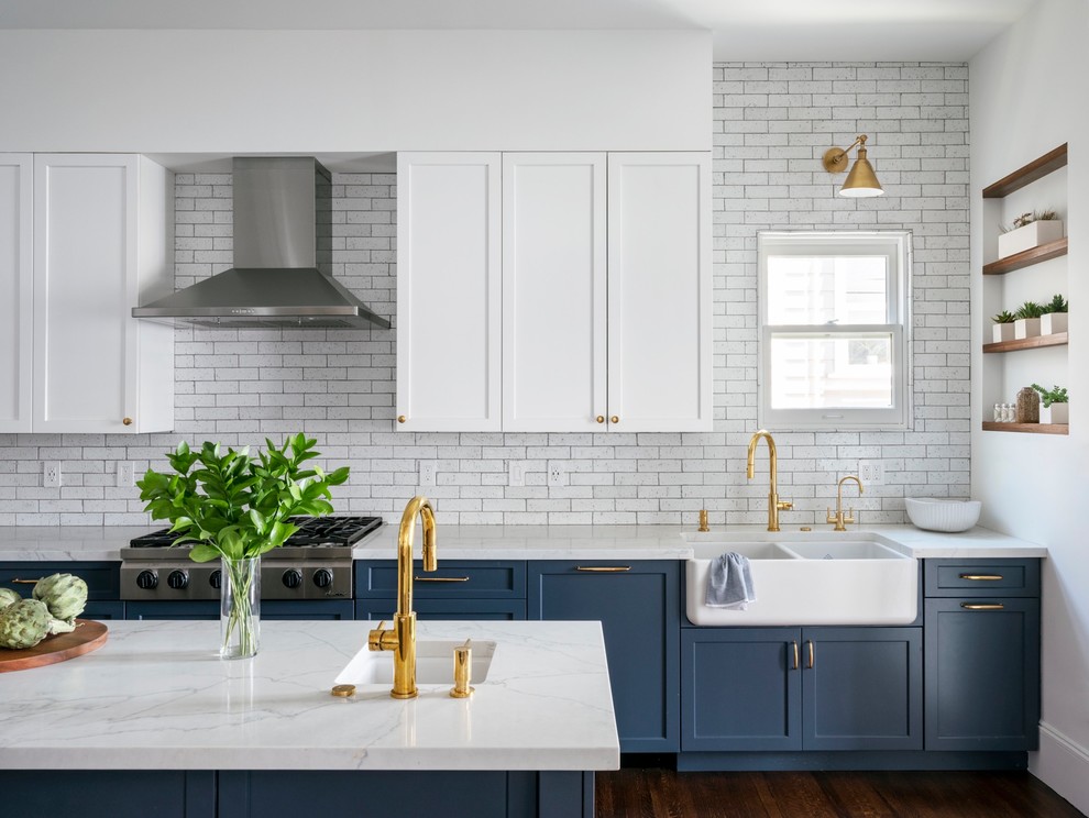 Kitchen - transitional brown floor and dark wood floor kitchen idea in San Francisco with a farmhouse sink, quartz countertops, white backsplash, stainless steel appliances, an island, white countertops, shaker cabinets, blue cabinets and subway tile backsplash