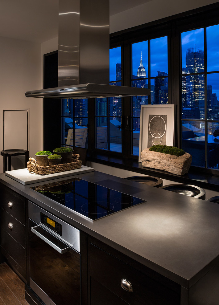 Kitchen - mid-sized contemporary dark wood floor kitchen idea in New York with dark wood cabinets, mirror backsplash and an island