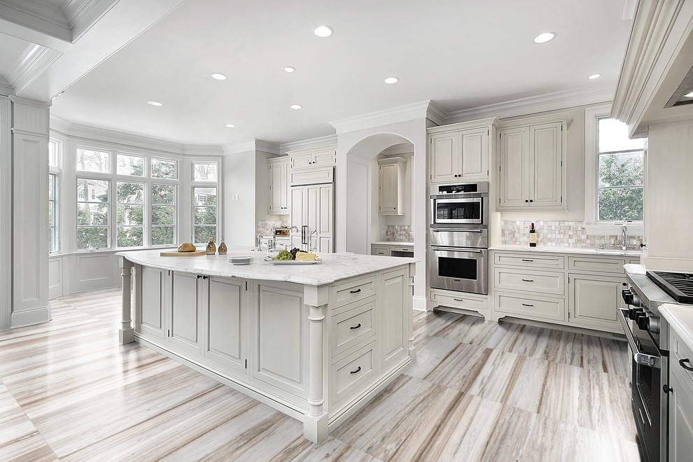 Inspiration for a traditional grey and cream kitchen/diner in Boston with white cabinets, marble worktops, marble flooring and an island.
