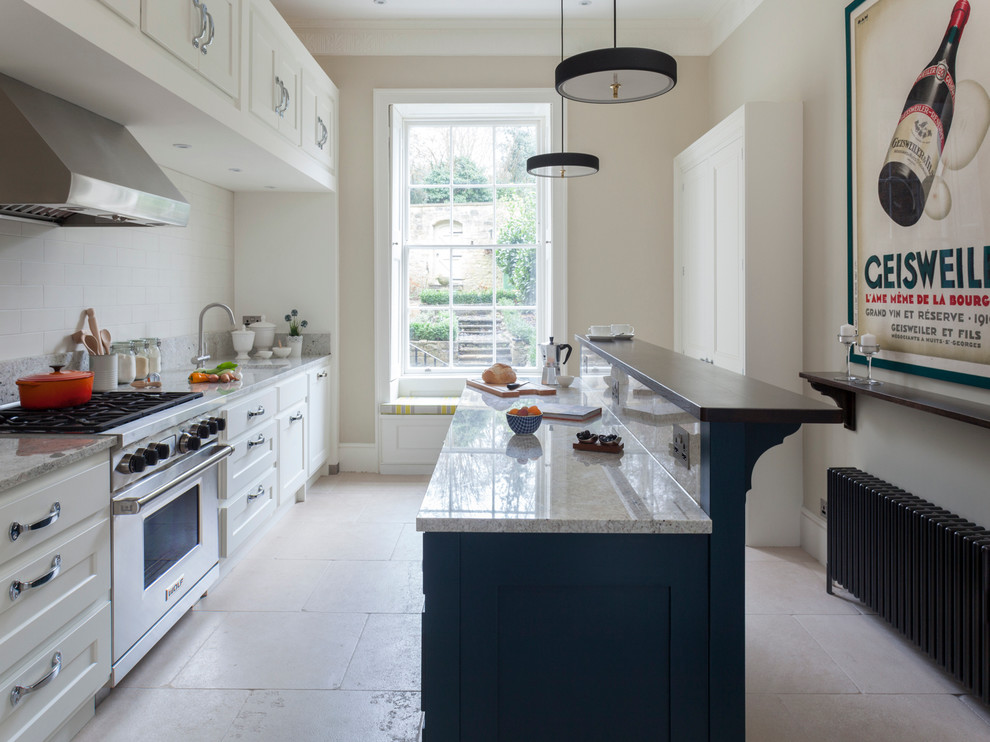 Example of a mid-sized classic single-wall kitchen design in Wiltshire with stainless steel appliances and an island
