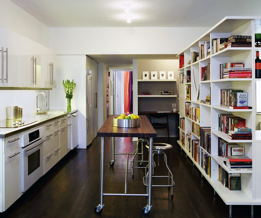 This is an example of a modern single-wall kitchen in New York with white appliances.