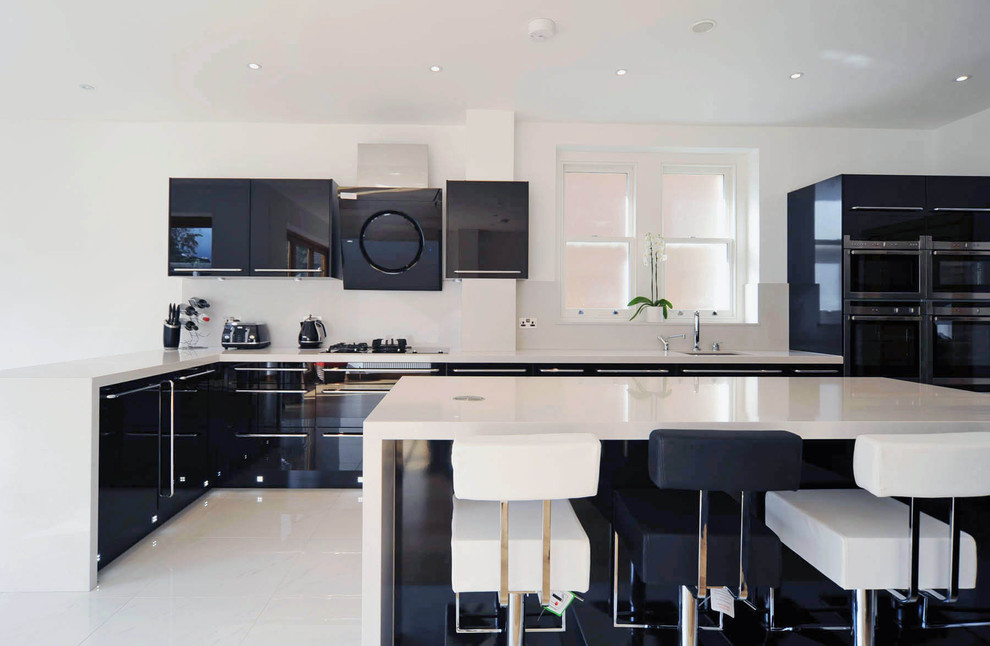 Design ideas for a contemporary kitchen in London with flat-panel cabinets.