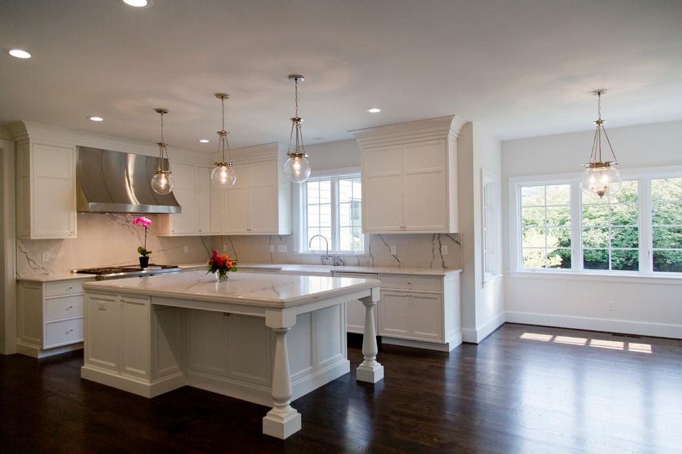 Large elegant u-shaped dark wood floor eat-in kitchen photo in St Louis with a farmhouse sink, recessed-panel cabinets, white cabinets, quartzite countertops, white backsplash, stone slab backsplash, stainless steel appliances and an island