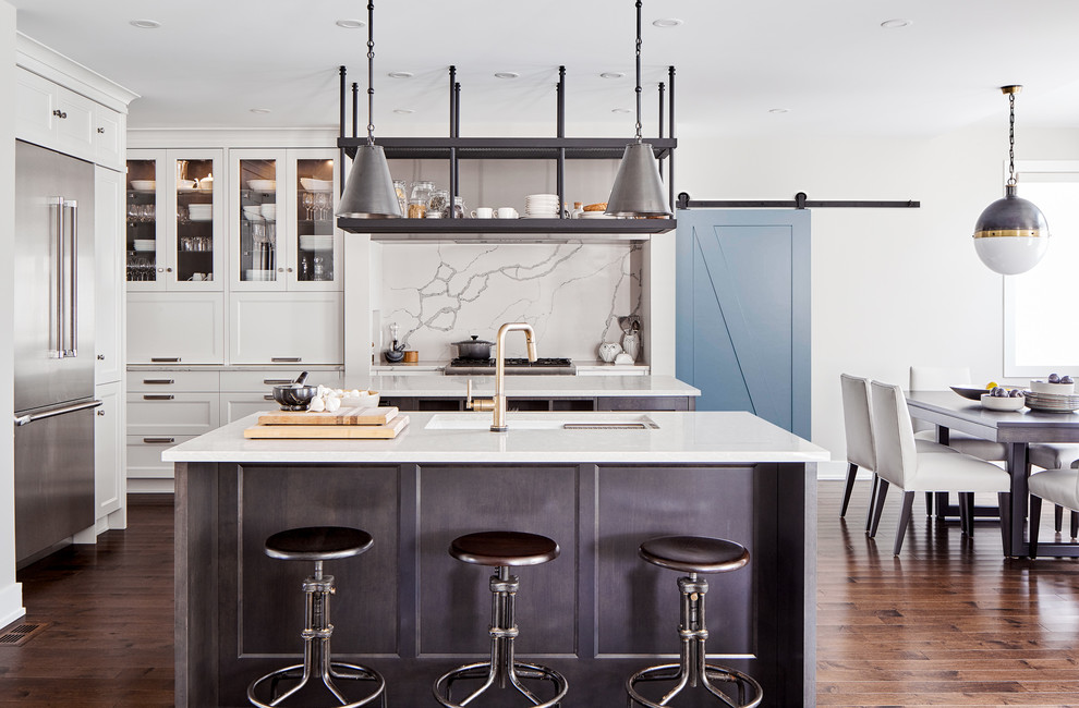 Photo of a large farmhouse kitchen/diner in Ottawa with a submerged sink, white cabinets, engineered stone countertops, white splashback, stone slab splashback, stainless steel appliances, dark hardwood flooring, multiple islands, brown floors, white worktops and glass-front cabinets.