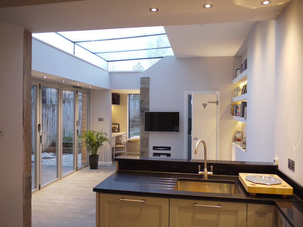 This is an example of a large contemporary kitchen in Edinburgh with porcelain flooring.