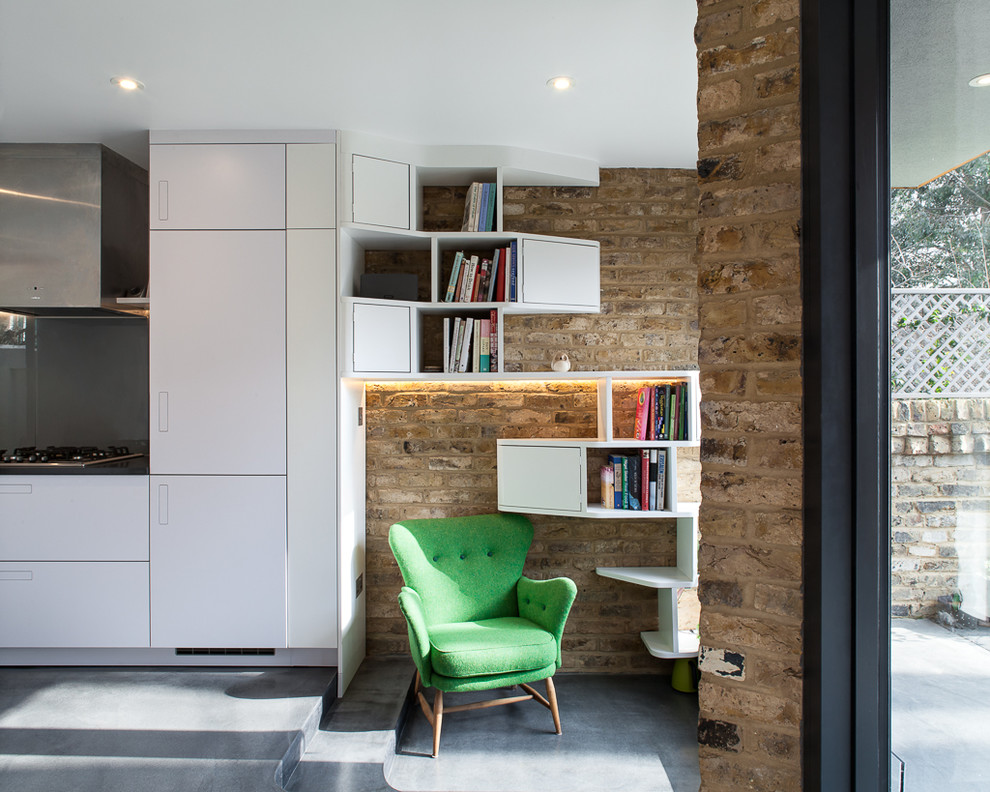 Design ideas for a large contemporary single-wall open plan kitchen in London with an integrated sink, flat-panel cabinets, white cabinets, composite countertops, grey splashback, integrated appliances, concrete flooring, grey floors and grey worktops.