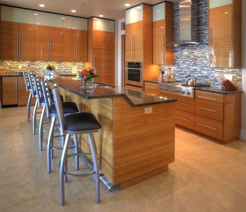 Photo of a medium sized contemporary galley open plan kitchen in Other with a submerged sink, flat-panel cabinets, dark wood cabinets, granite worktops, multi-coloured splashback, matchstick tiled splashback, stainless steel appliances, travertine flooring, an island and beige floors.