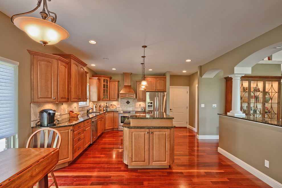 Mid-sized elegant l-shaped dark wood floor enclosed kitchen photo in St Louis with an undermount sink, raised-panel cabinets, light wood cabinets, granite countertops, beige backsplash, mosaic tile backsplash, stainless steel appliances and an island