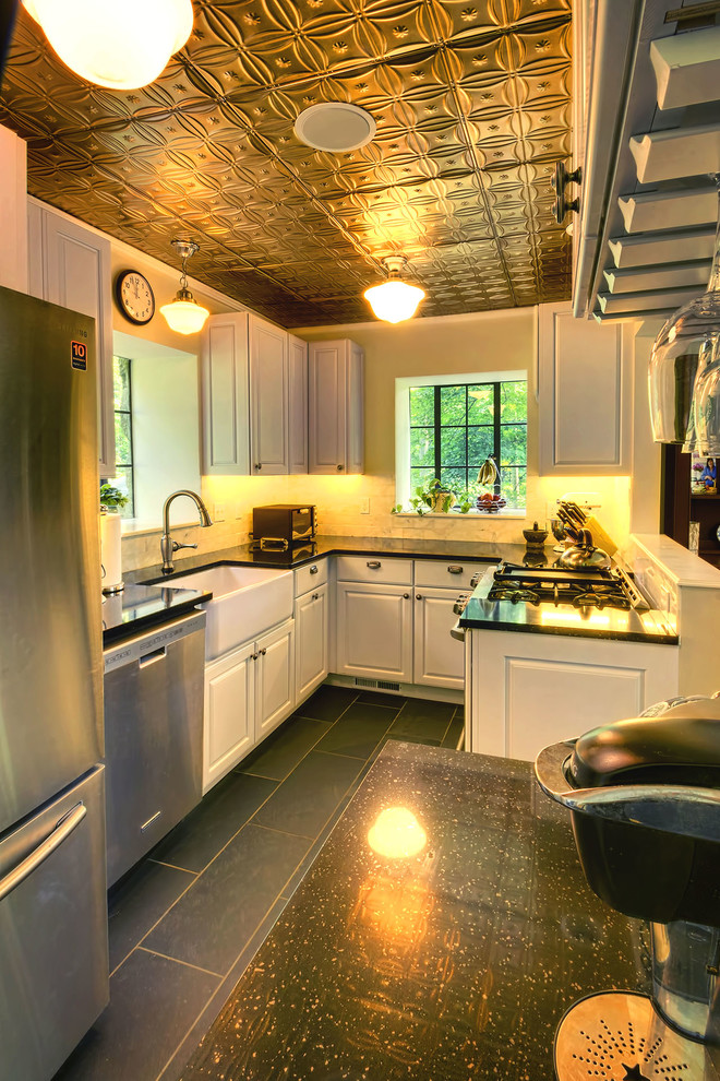 Inspiration for a small rustic u-shaped kitchen/diner in New York with a belfast sink, raised-panel cabinets, white cabinets, soapstone worktops, white splashback, metro tiled splashback, stainless steel appliances and slate flooring.