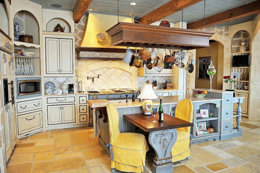 Inspiration for a large mediterranean l-shaped limestone floor kitchen pantry remodel in Los Angeles with an undermount sink, shaker cabinets, beige cabinets, limestone countertops, beige backsplash, stone tile backsplash, colored appliances and two islands
