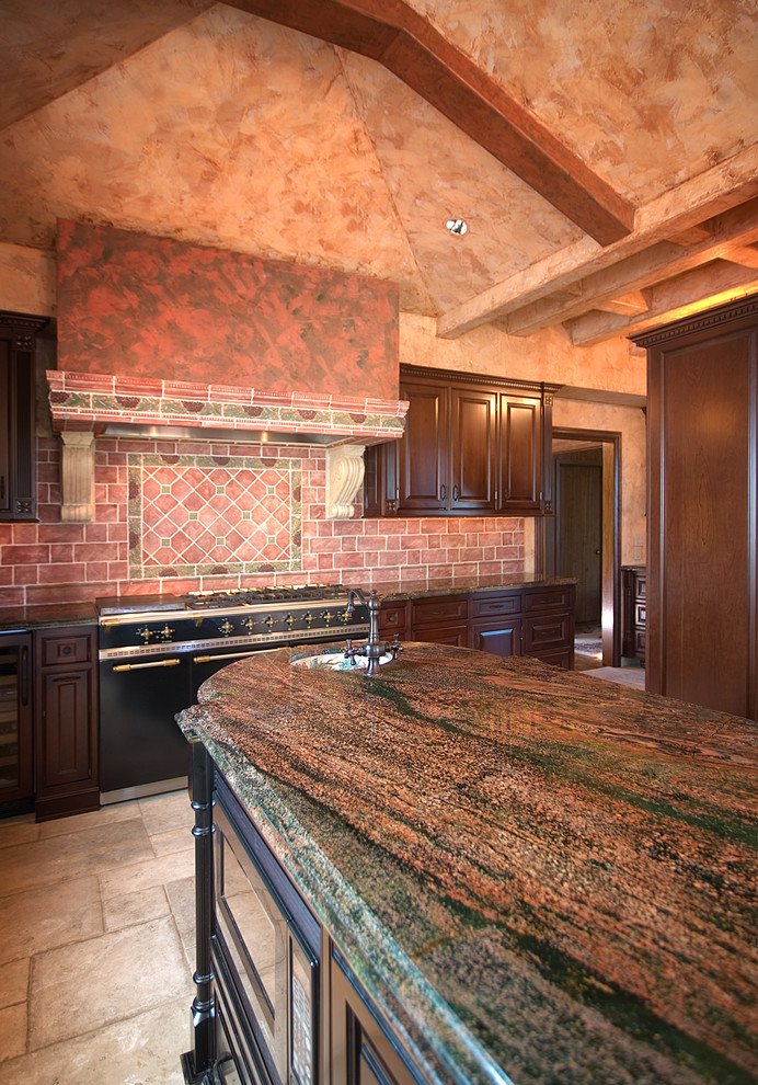 This is an example of a medium sized classic l-shaped kitchen/diner in Seattle with raised-panel cabinets, dark wood cabinets, granite worktops, red splashback, ceramic splashback, stainless steel appliances, a single-bowl sink, travertine flooring and an island.