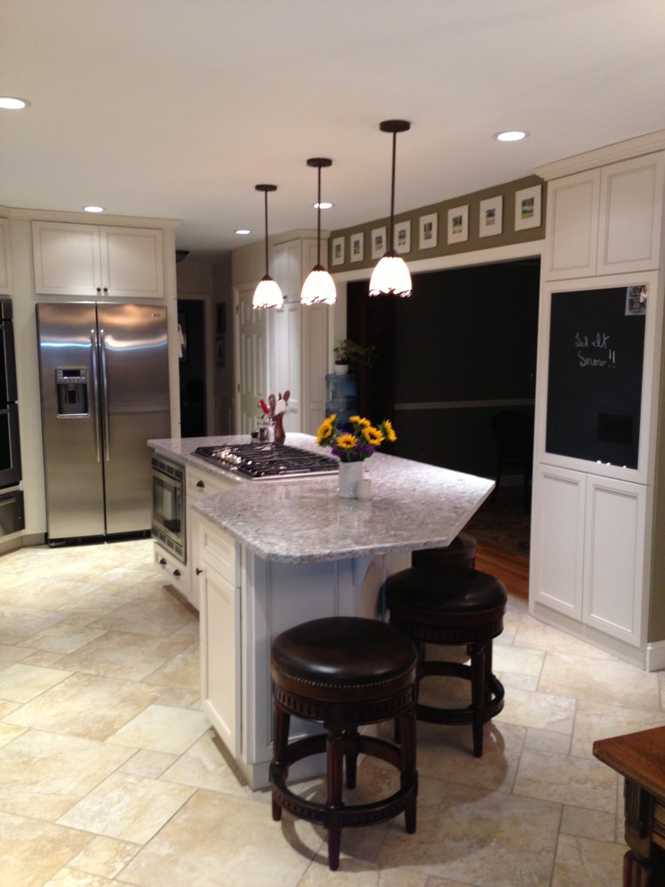 Eat-in kitchen - mid-sized traditional u-shaped ceramic tile and gray floor eat-in kitchen idea in New York with an undermount sink, recessed-panel cabinets, white cabinets, granite countertops, gray backsplash, ceramic backsplash, stainless steel appliances and an island