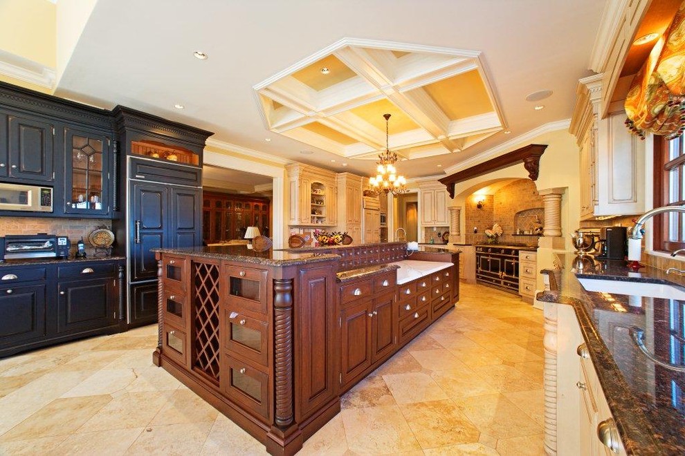 Large classic l-shaped kitchen/diner in Newark with a submerged sink, beaded cabinets, black cabinets, granite worktops, beige splashback, stone tiled splashback, black appliances, travertine flooring, an island and beige floors.