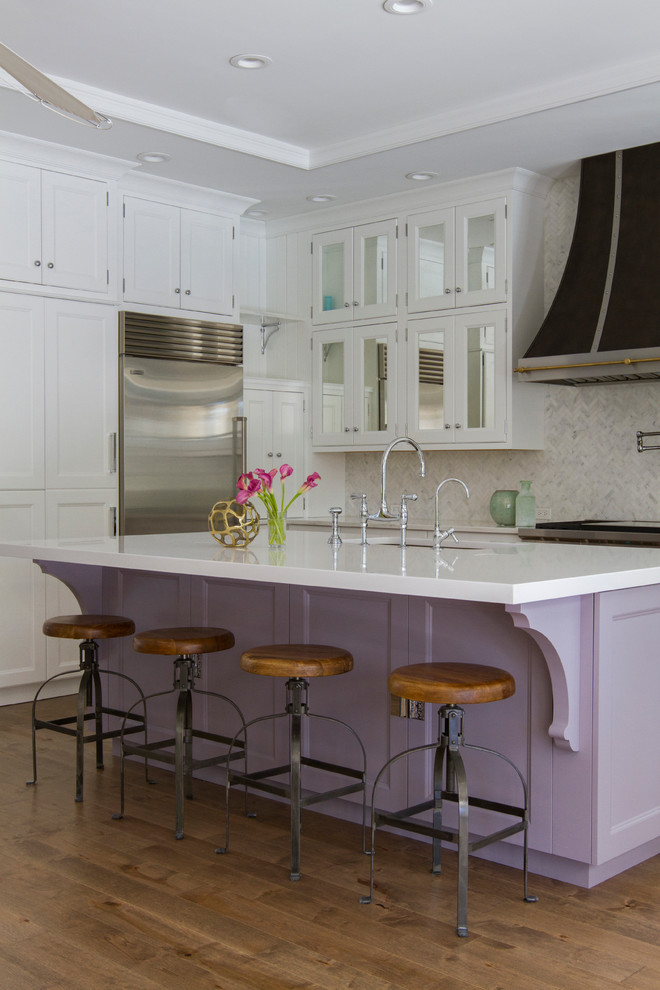 Inspiration for a transitional medium tone wood floor kitchen remodel in Jacksonville with an undermount sink, shaker cabinets, white cabinets, multicolored backsplash, stainless steel appliances and an island