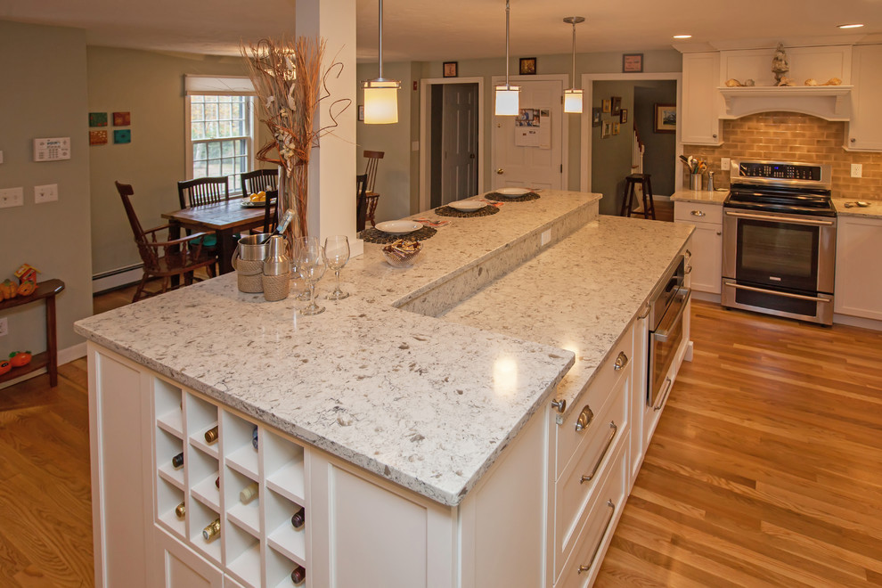 Large elegant l-shaped light wood floor and brown floor eat-in kitchen photo in Boston with an undermount sink, flat-panel cabinets, white cabinets, quartz countertops, brown backsplash, ceramic backsplash, stainless steel appliances and an island