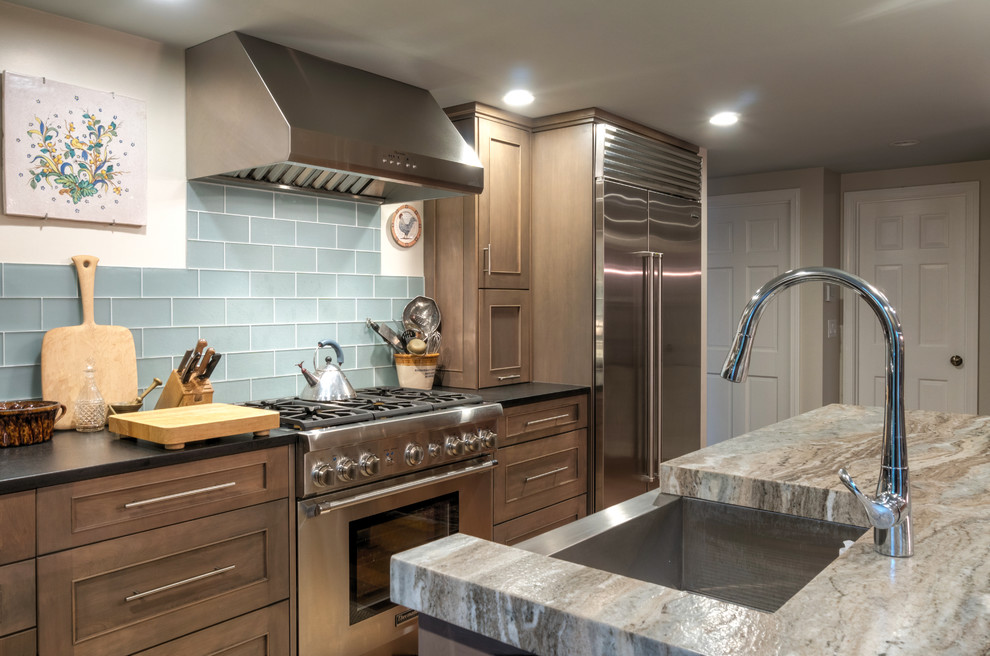 Large arts and crafts l-shaped light wood floor and brown floor eat-in kitchen photo in Boston with an integrated sink, recessed-panel cabinets, gray cabinets, granite countertops, blue backsplash, ceramic backsplash, stainless steel appliances and an island